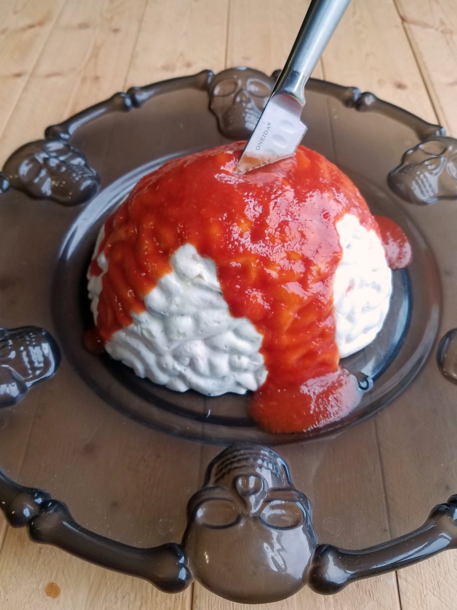 knife in brain shaped mold with cocktail sauce blood.