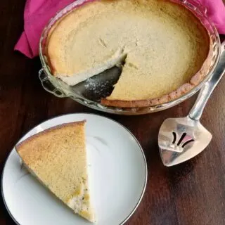 first slice of pie served with remaining pie nearby.