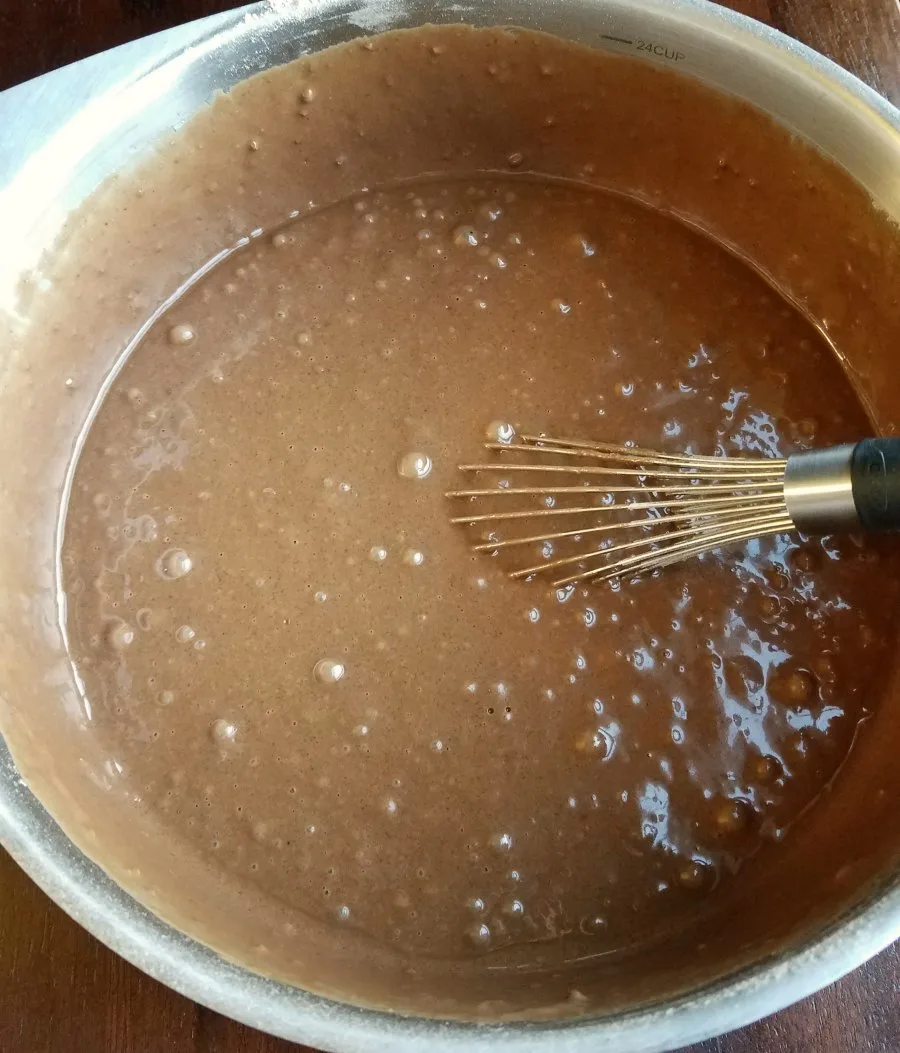 devilishly good chocolate cupcakes batter in mixing bowl with whisk.