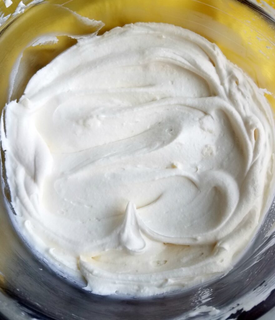 smoothed out bowl of lemon frosting