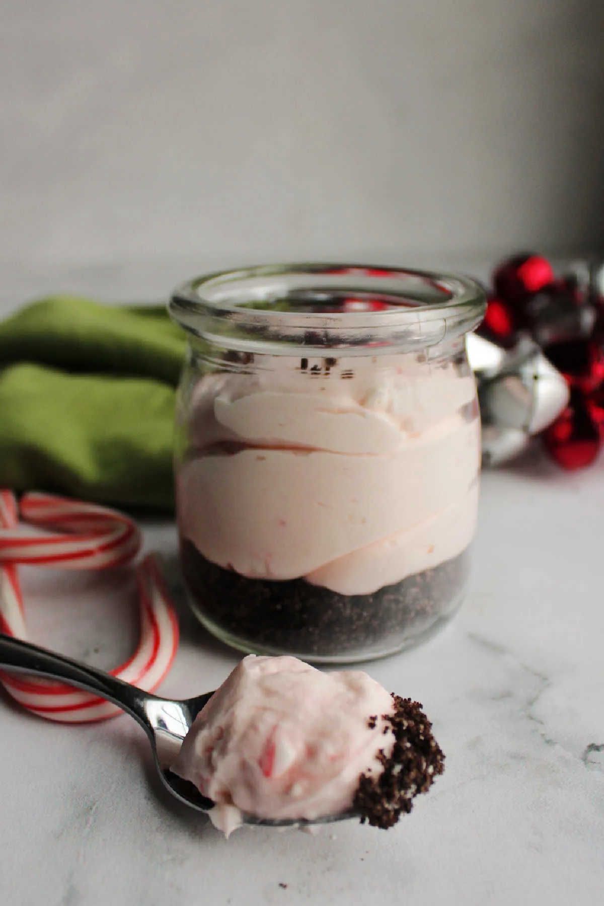 Bite of peppermint no bake cheesecake on spoon ready to eat. 