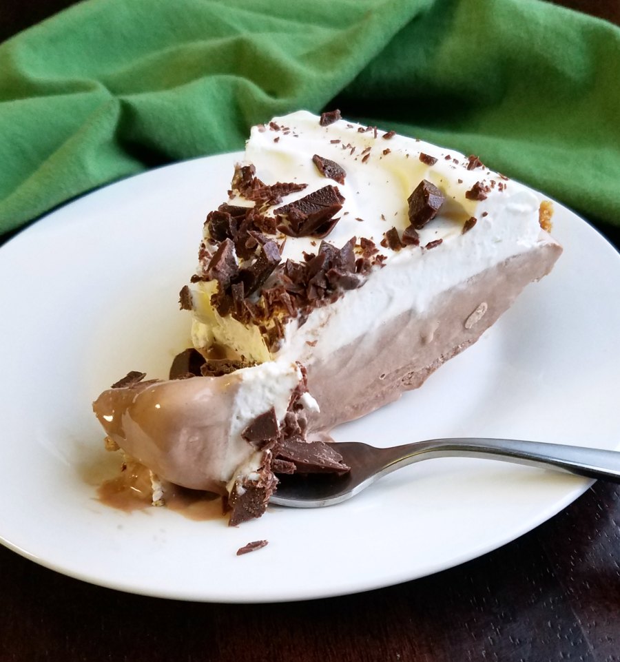 slice of frozen chocolate pie with whipped cream and chopped chocolate mints on top