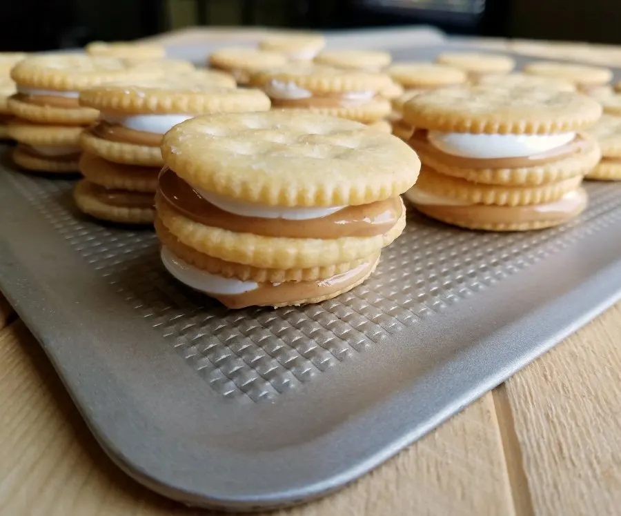 stacks of cracker sandwiches with peanut butter and marshmallow fluff inside, waiting to be dipped.