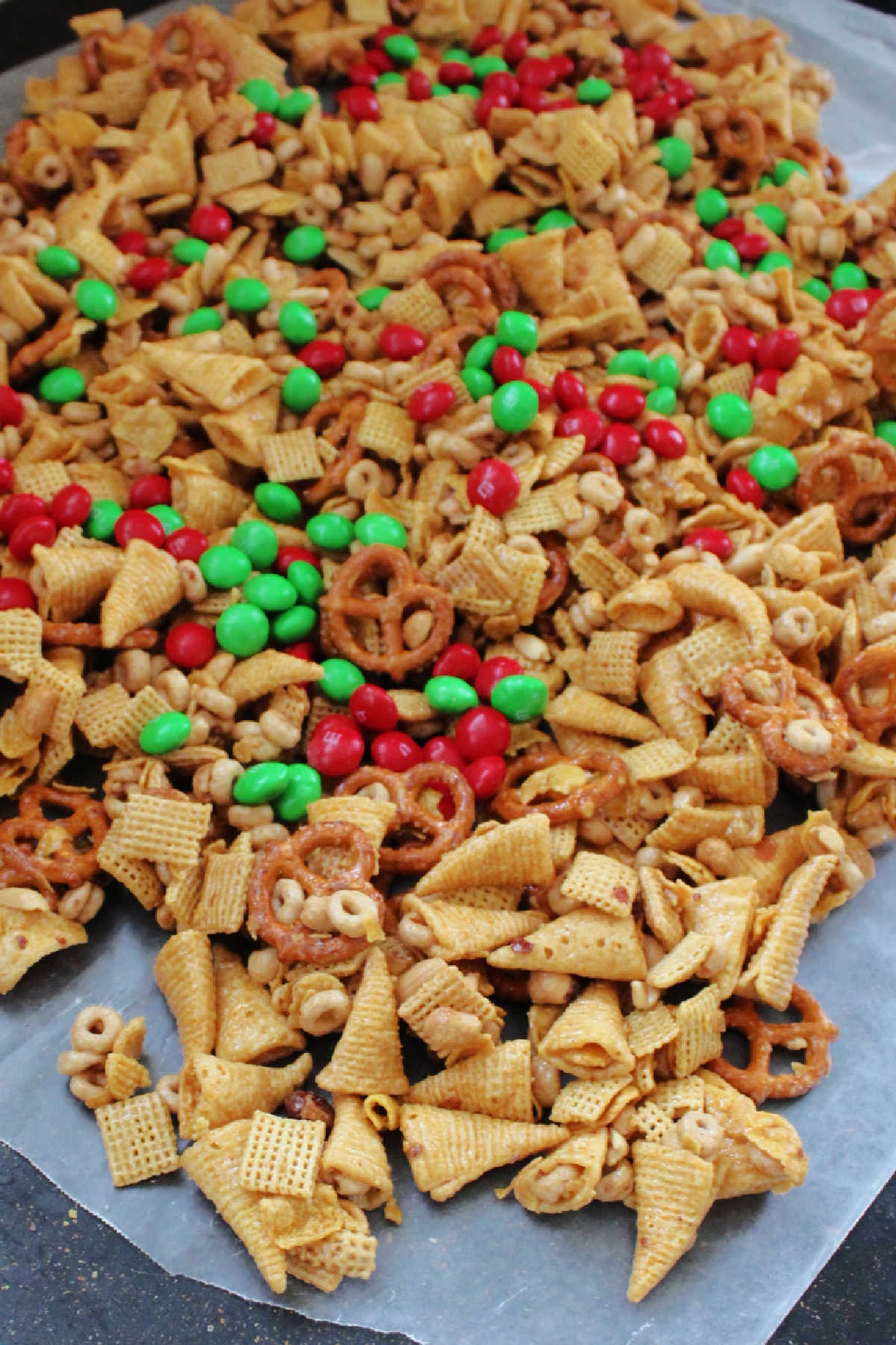Caramel snack mix with bugles, pretzels and more coated in caramel mixture and cooked until crunchy cooling on wax paper.