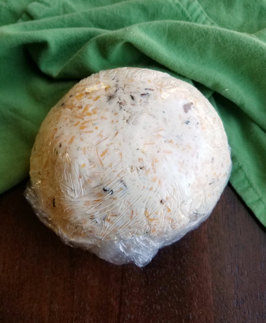 cheese ball wrapped in plastic wrap ready to chill.