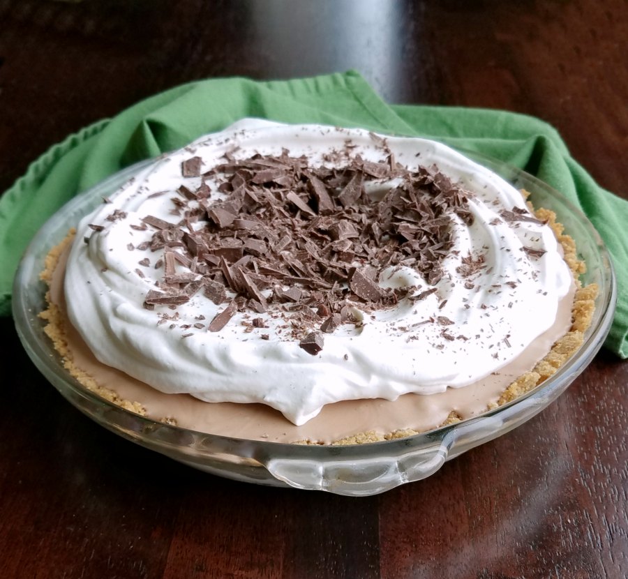 Frozen mint meltaway pie topped with whipped cream and chopped Frango mints, ready to be served. 