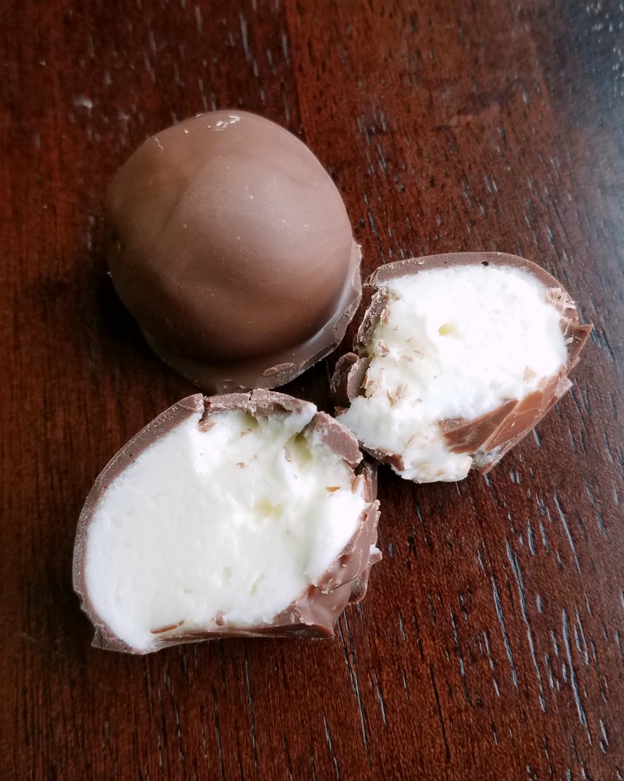 a whole truffle next to one cracked open to show the center.