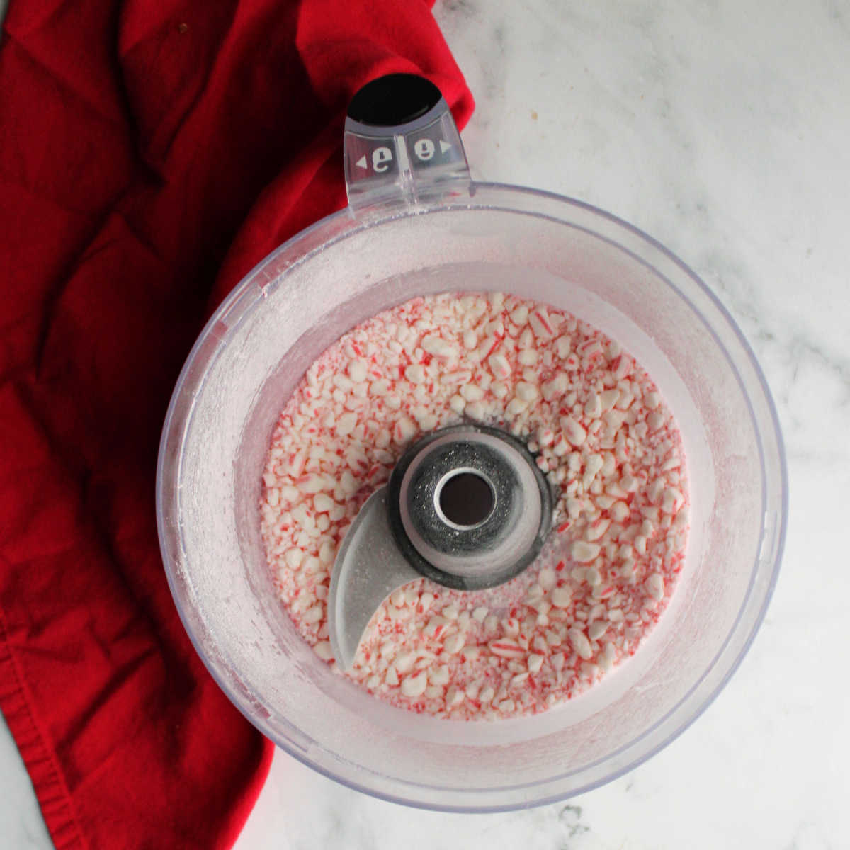 Food processor with candy cane bits inside. 