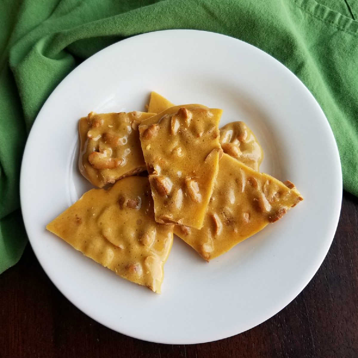 plate of pieces of easy microwave peanut brittle.