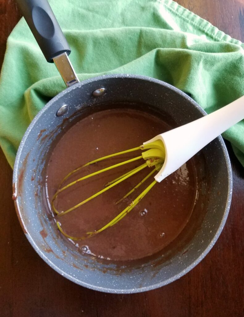 Melted frango mint custard in saucepan with whisk. 