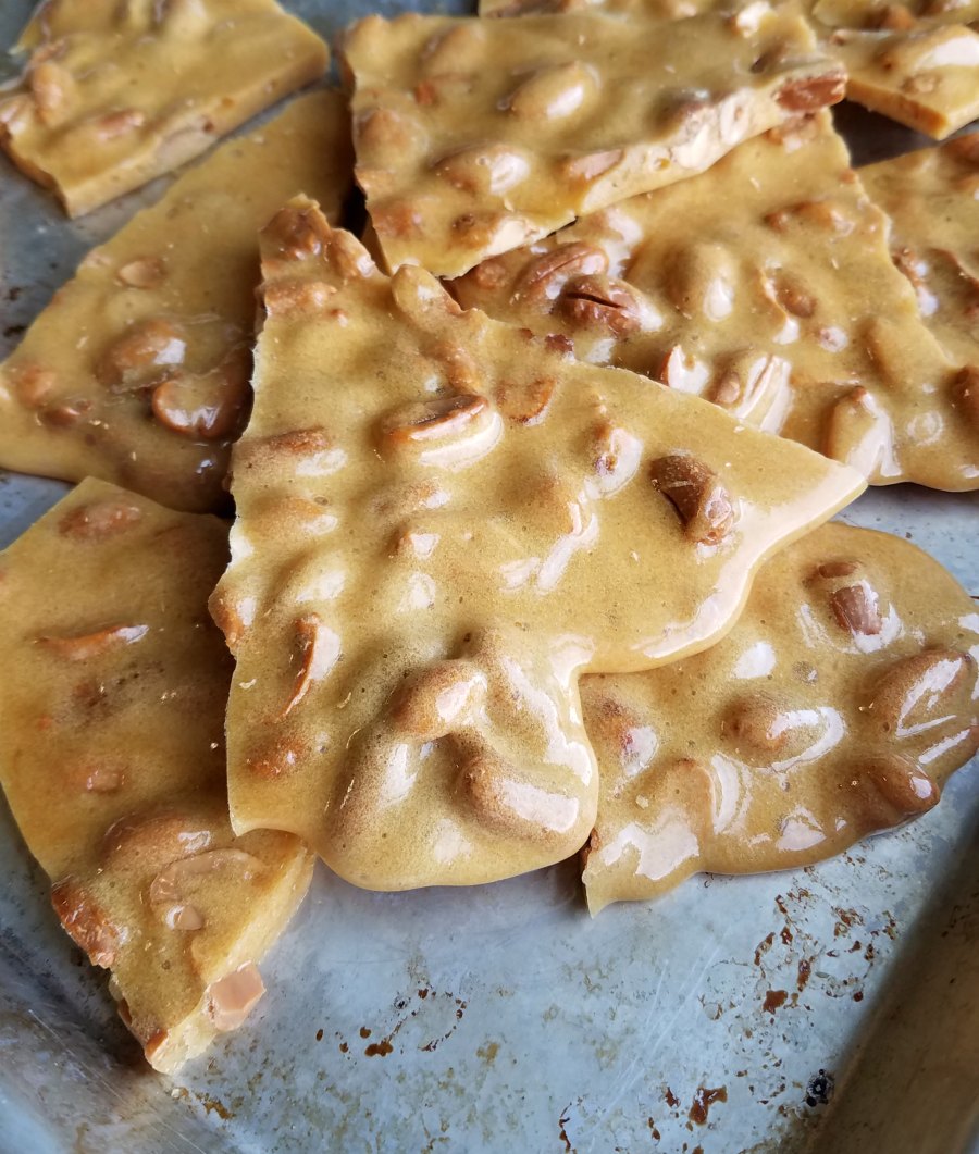 shards of microwave peanut brittle on baking sheet