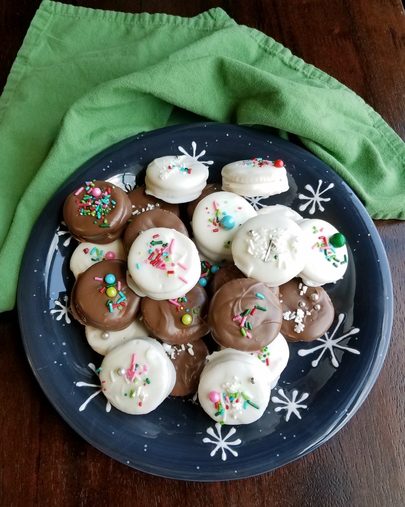 white and milk chocolate dipped fluffernutter sandwich cookies on plate