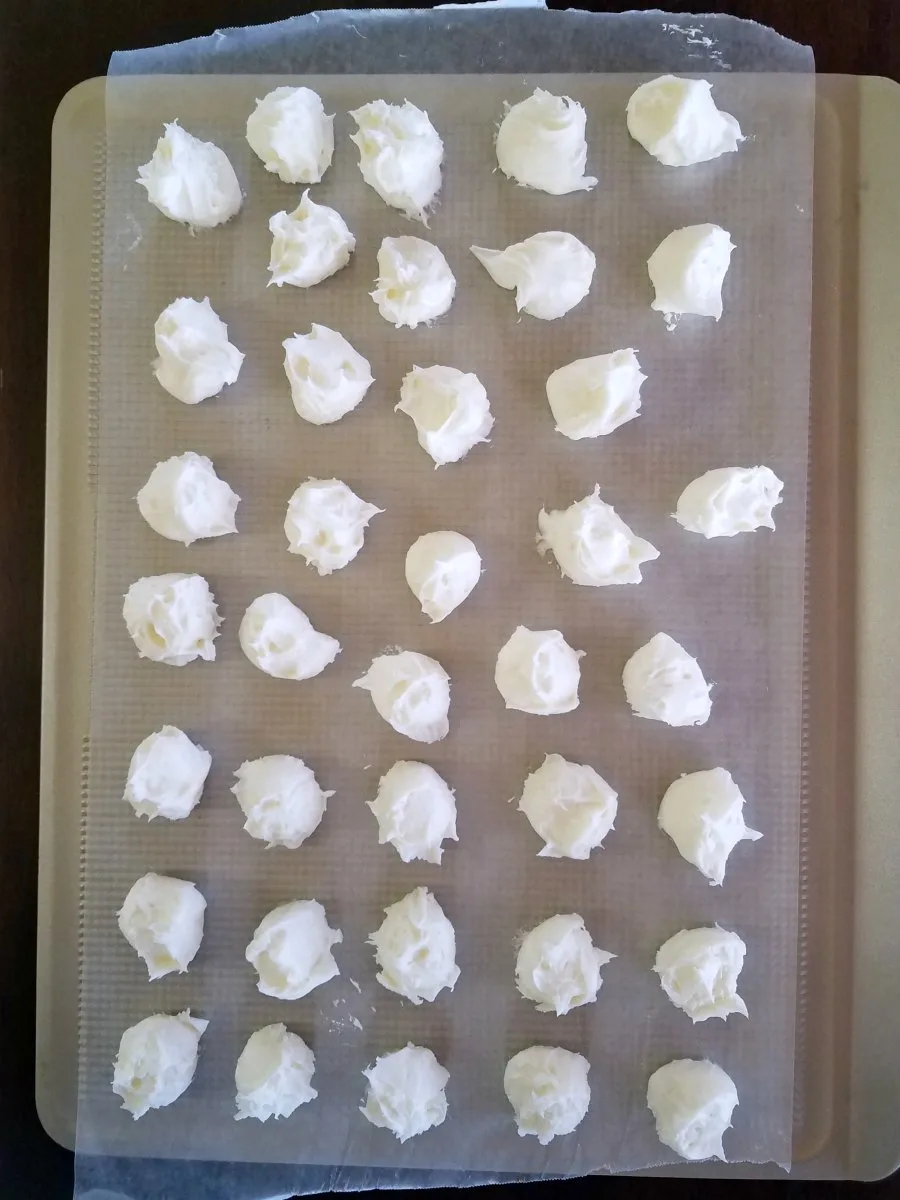 balls of creamy centers scooped onto wax paper and ready to freeze.