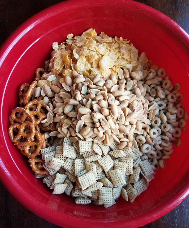 bowl of pretzels, cereals, peanuts etc ready to be made into snack mix.