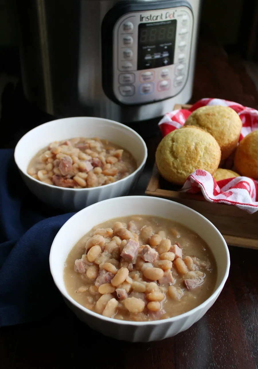 two bowls of ham and beans with corn muffins and instant pot