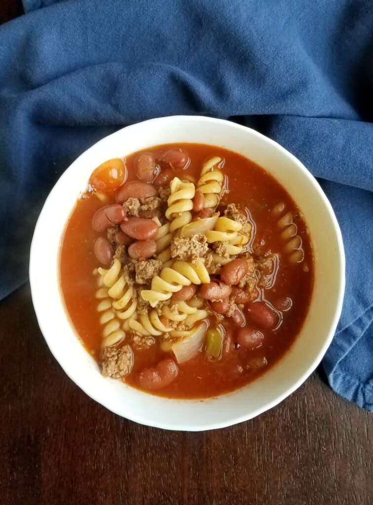 bowl of chili soup with pasta in it.