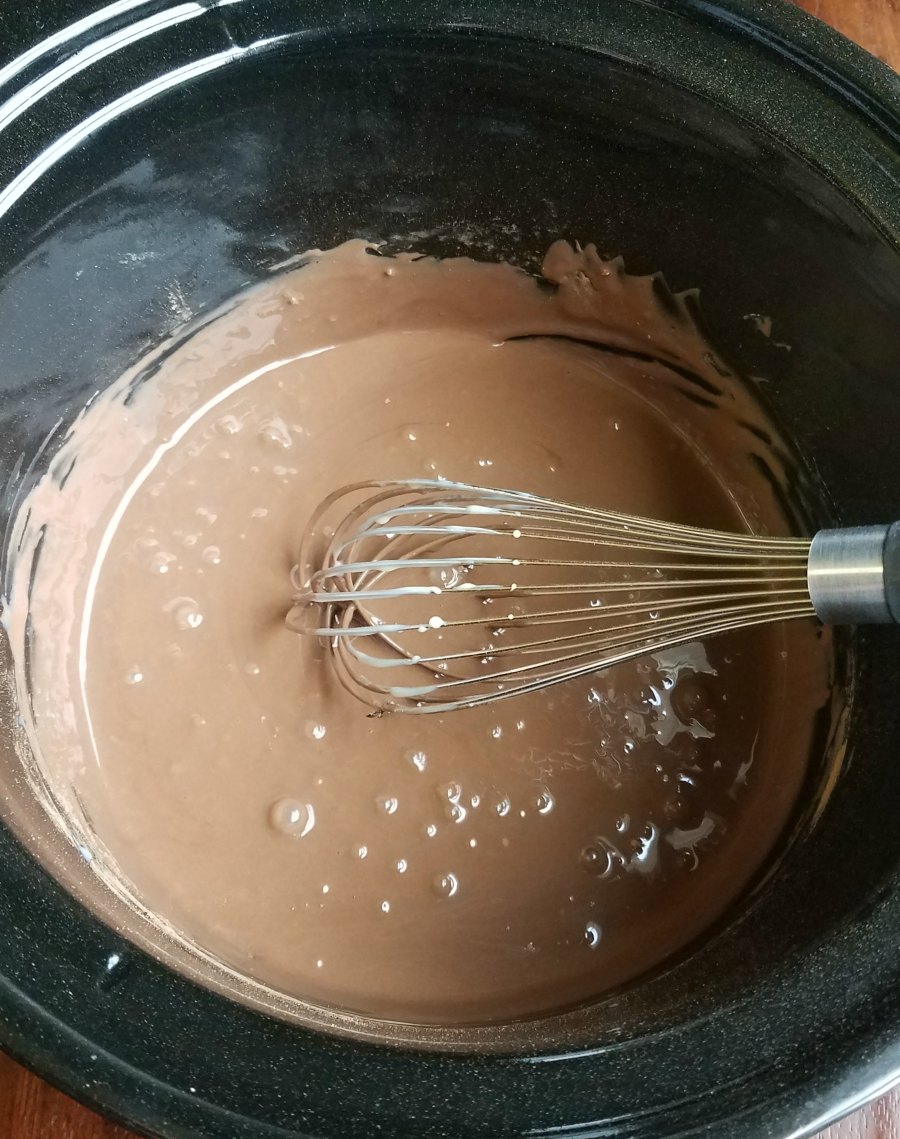 cocoa powder and sweetened condensed milk whisked together in slow cooker