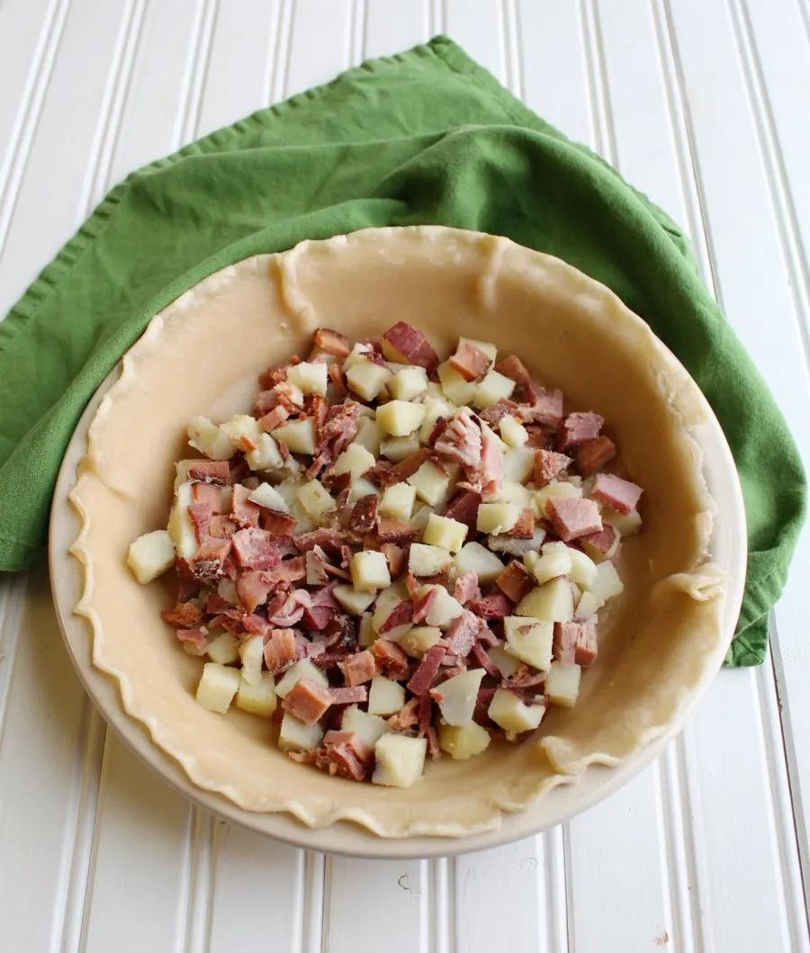 pie shell filled with ham and potatoes.