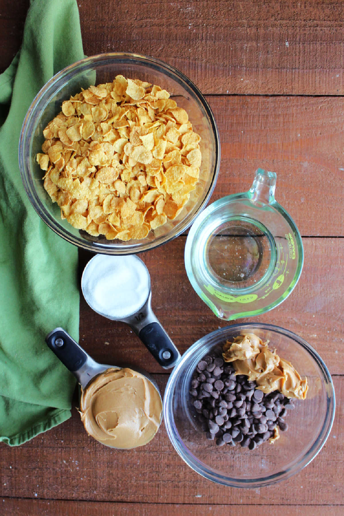 Ingredients: corn flakes, peanut butter, sugar, corn syrup and chocolate chips ready to be made into scotcharoo bars. 