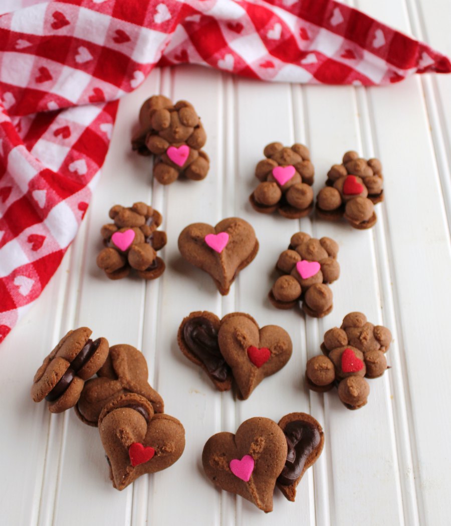 chocolate spritz cookies with chocolate ganache between them for Valentine's Day.
