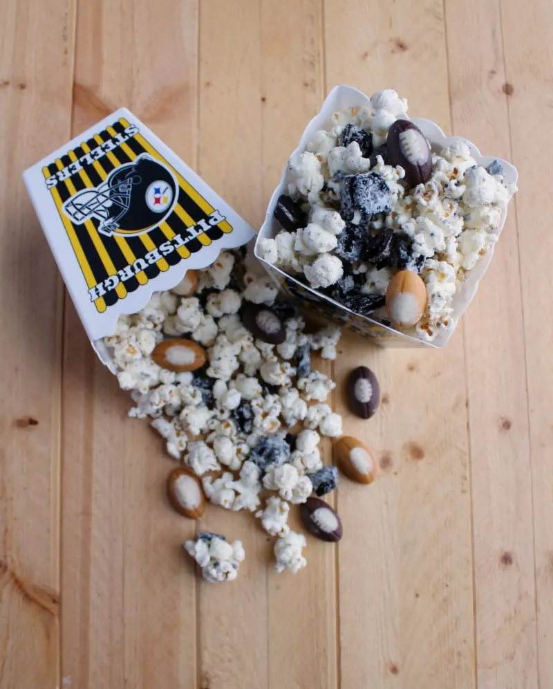 containers of cookies and cream popcorn with little candy footballs added.