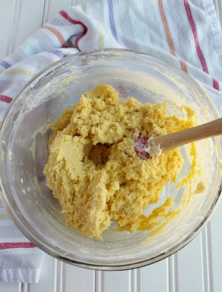 bowl of yellow cookie dough for gooey butter cookies.