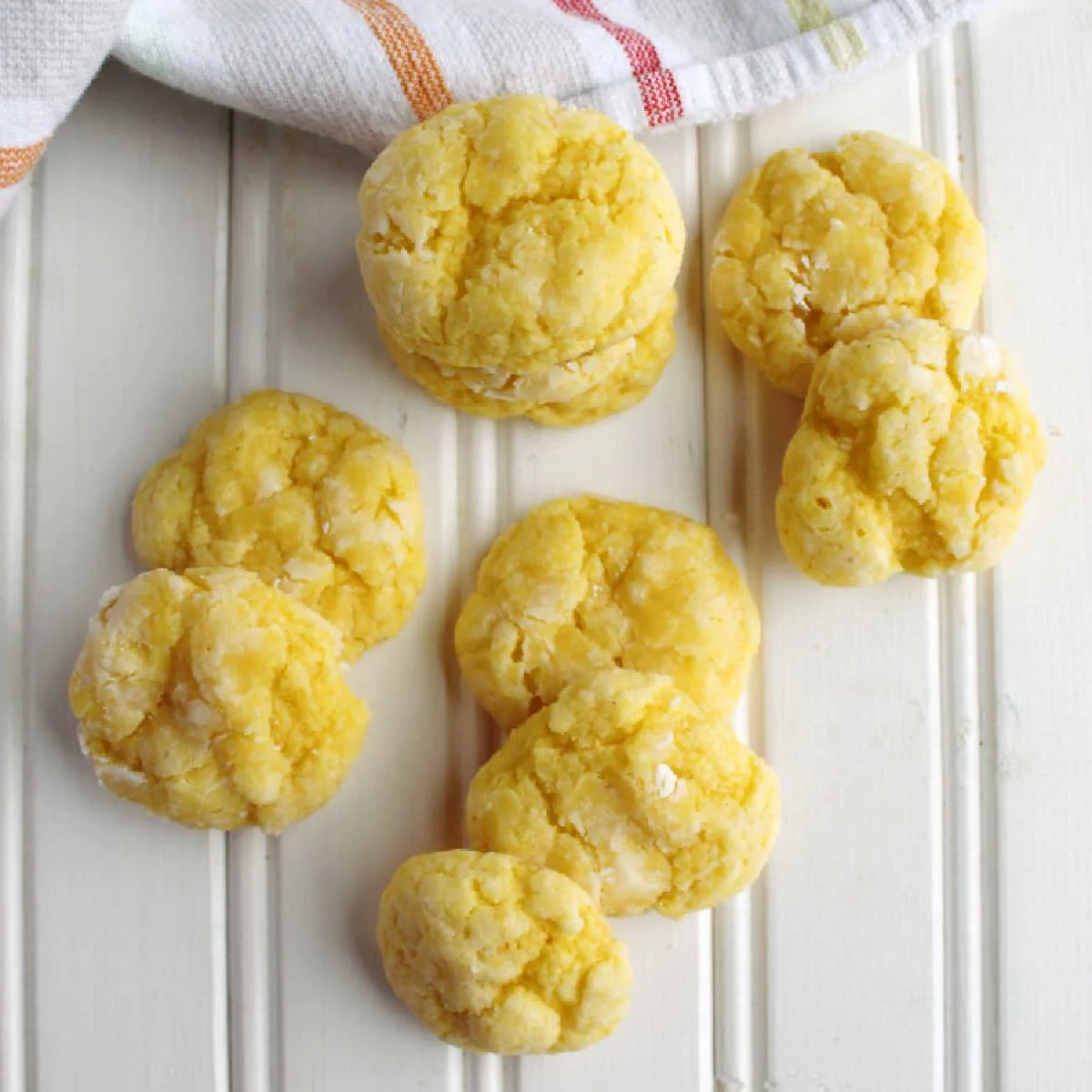 Soft lemon cookies with crackly powdered sugar exterior, ready to eat.