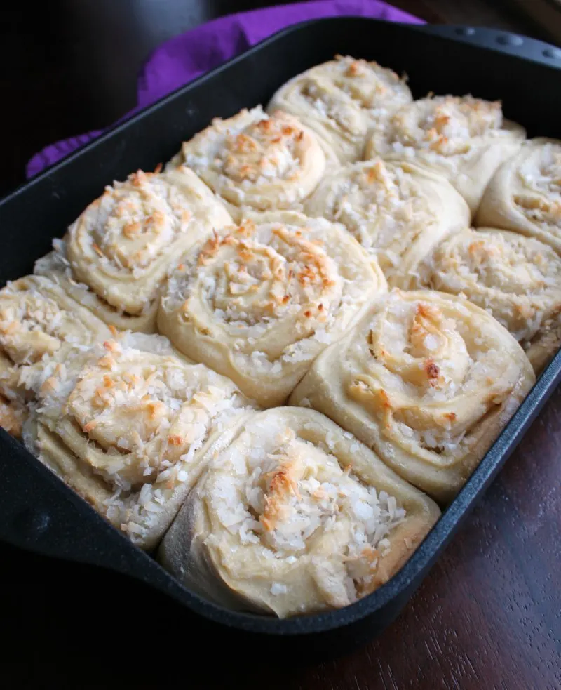 pan full of coconut sweet rolls fresh from the oven.