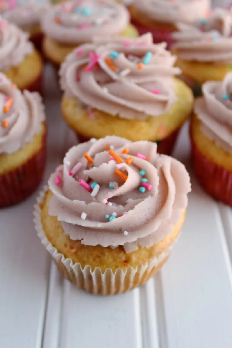 cupcakes decorated with sugar cookie dough frosting and cute sprinkles.