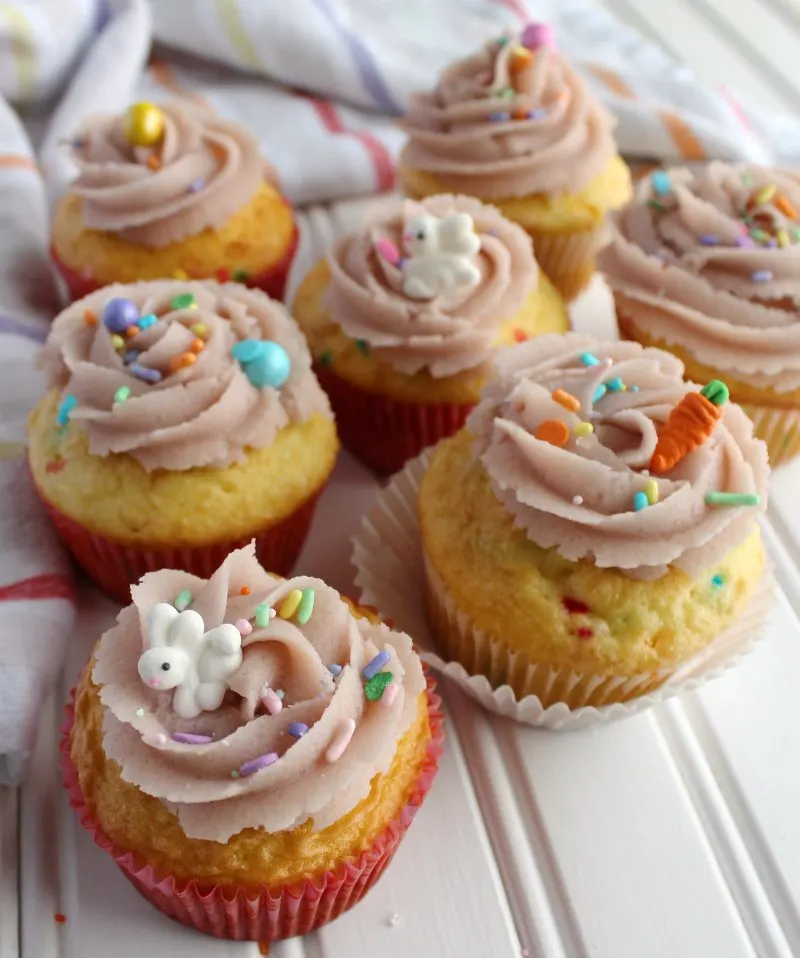sugar cookie dough frosting swirls on cupcakes with cute bunny and carrot sprinkles.