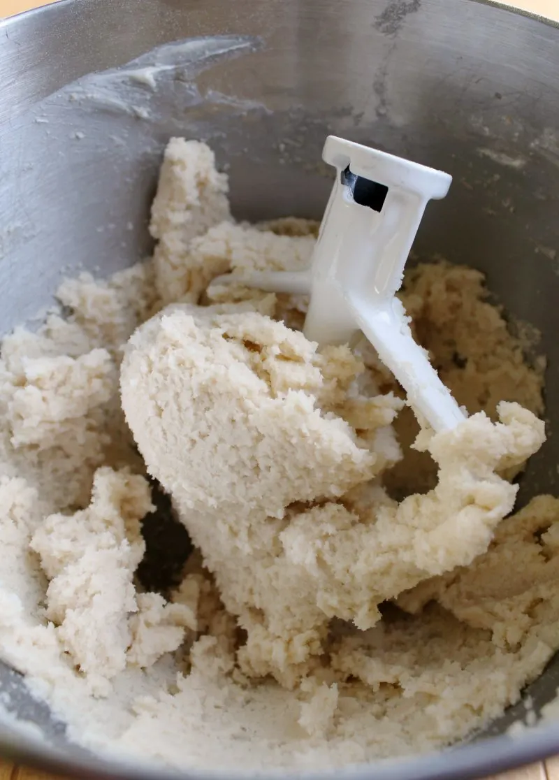 mixing bowl of sugar cookie dough frosting with paddle.
