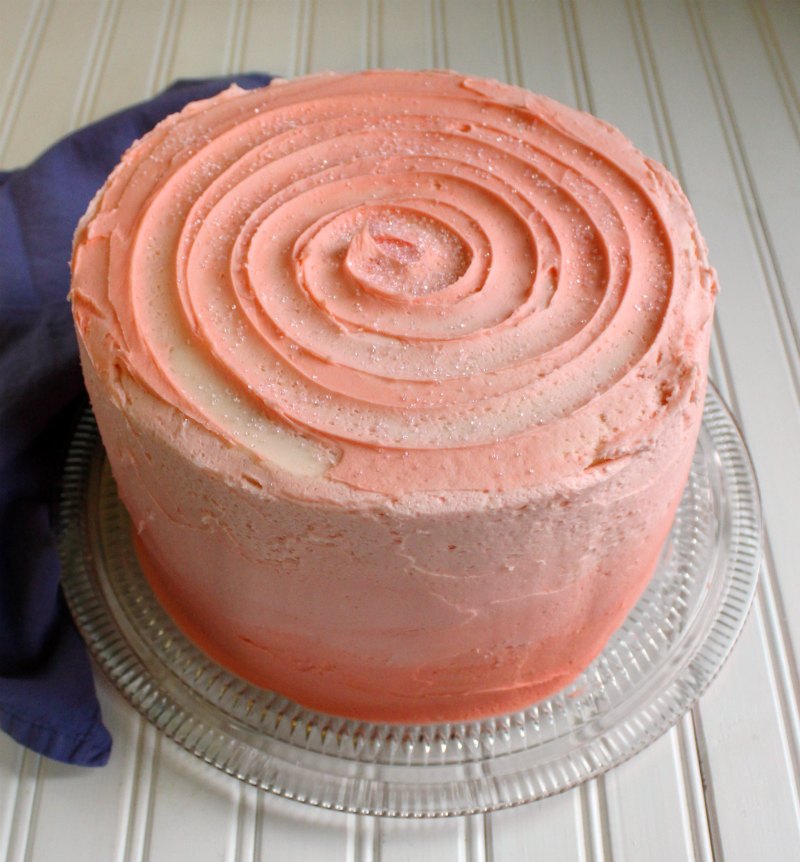 cake with pink ombre effect on the sides and a pink swirl on the top