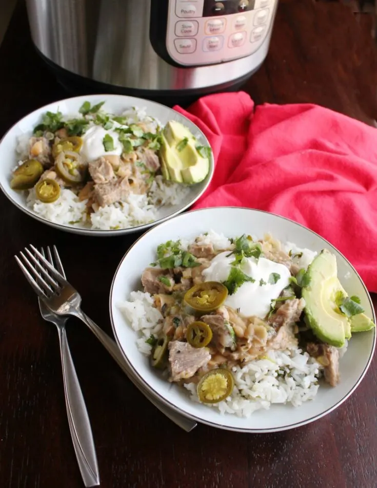 pork burrito bowls with garnishes in front of instant pot.
