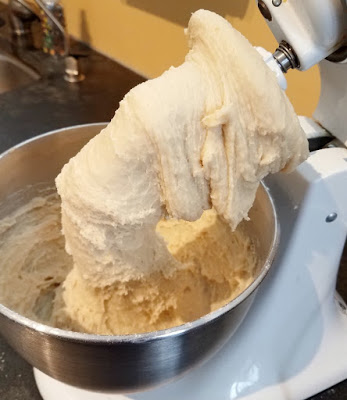 loose enriched dough on dough hook in mixer