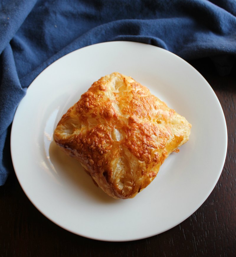 golden brown ham egg and cheese hand pie on plate.