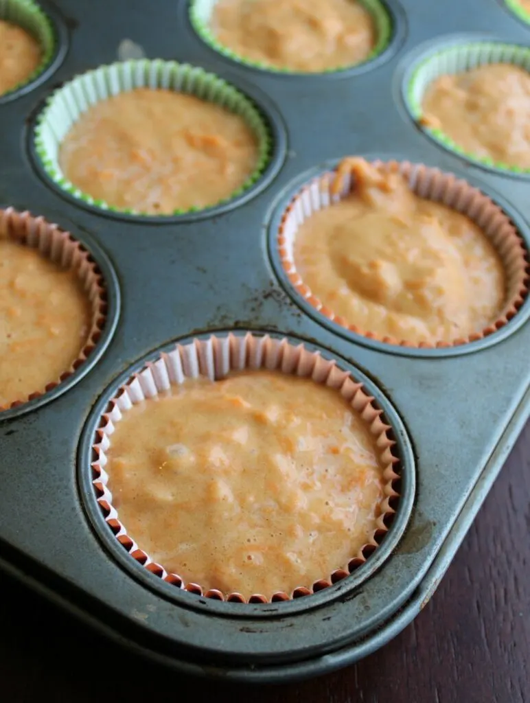 carrot cake batter in cupcake liners in tin.