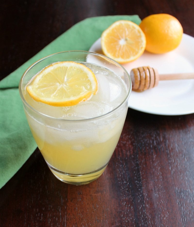 Honey Lemonade 8 glass of lemonade with slices of lemon and honey drizzler