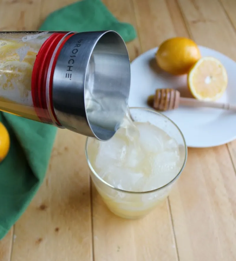 pouring glass of honey lemonade.