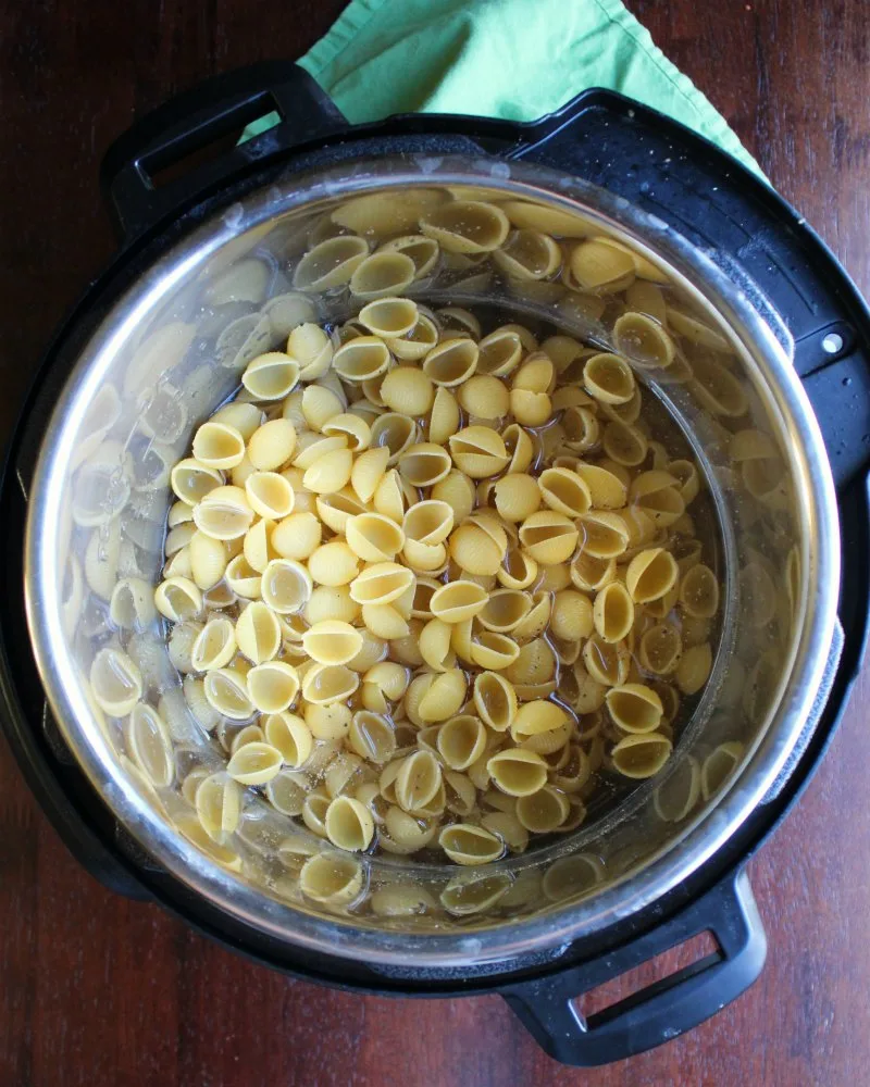 pasta and water in instant pot ready to cook.
