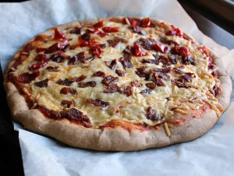 a bacon and red pepper pizza made on whole wheat pizza crust.