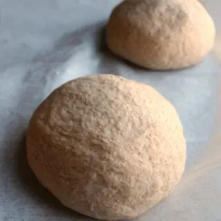 two balls of whole wheat pizza dough.