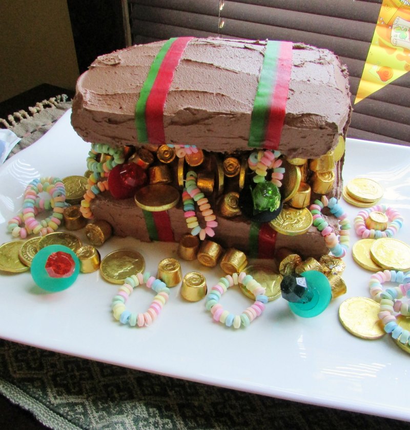 treasure chest cake with chocolate frosting and lots of candy treasure.