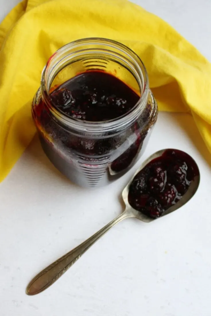 blackberry sauce in jar and on spoon
