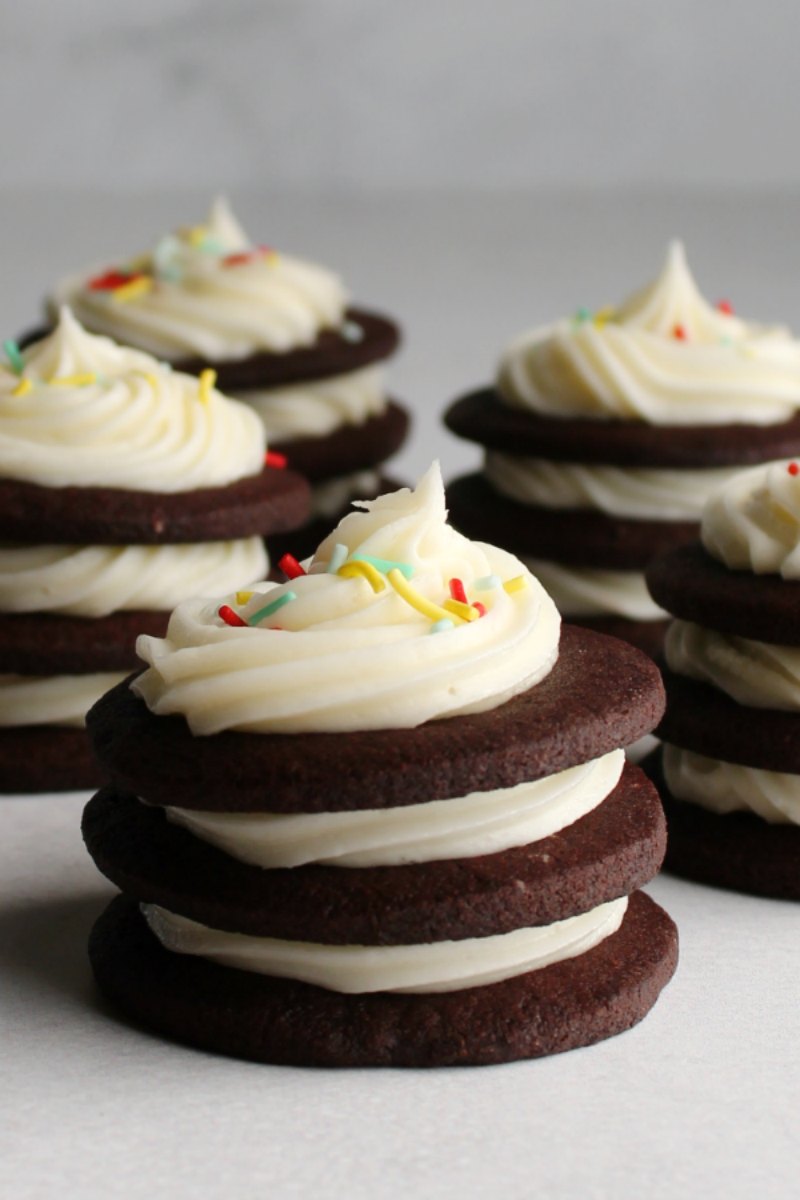 dark chocolate cookie stacks with cream cheese frosting piped between the layers.
