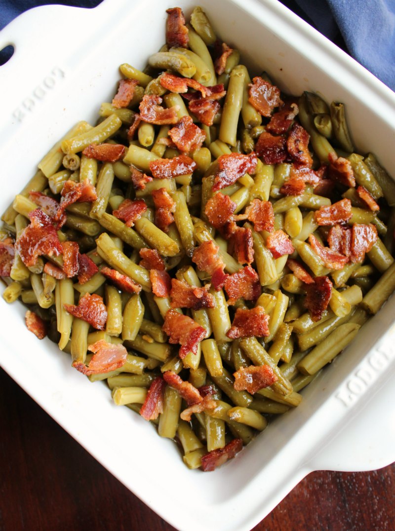 square pan of green beans and bacon smothered in delicious sauce straight from the oven.