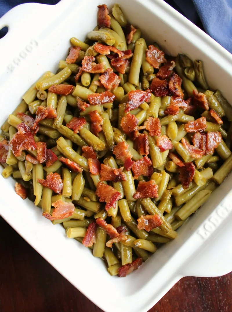 square pan of green beans and bacon smothered in delicious sauce straight from the oven.
