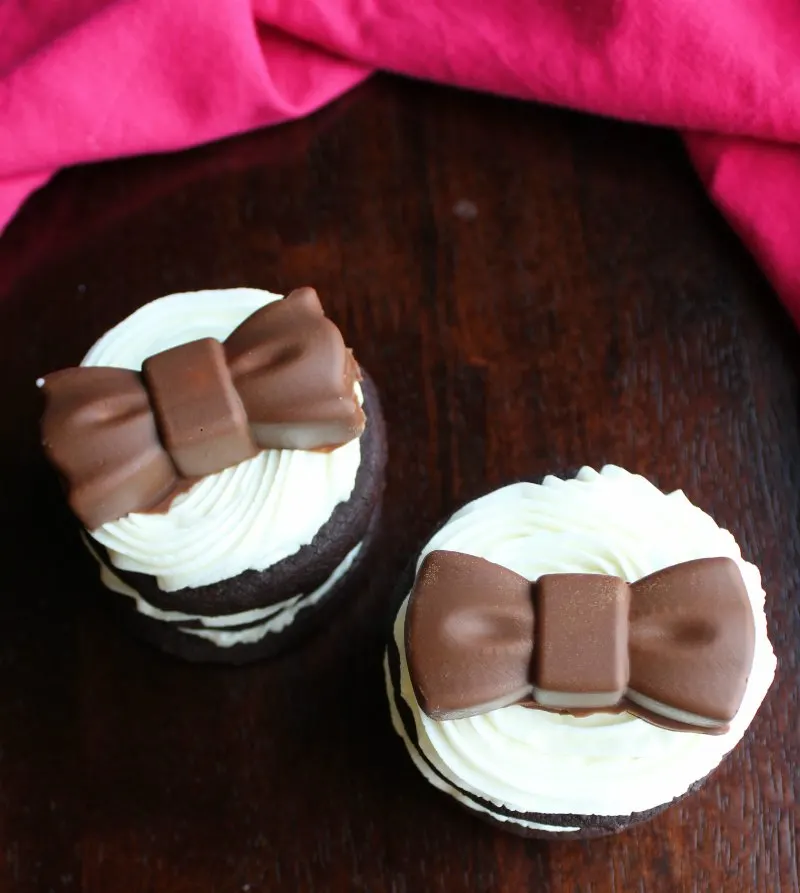 chocolate sandwich cookie stacks with chocolate bows on top.