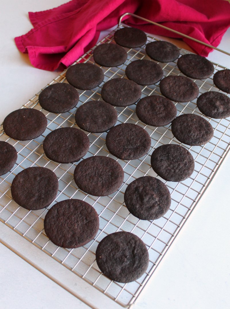 dark chocolate cookie circles on cooling rack.