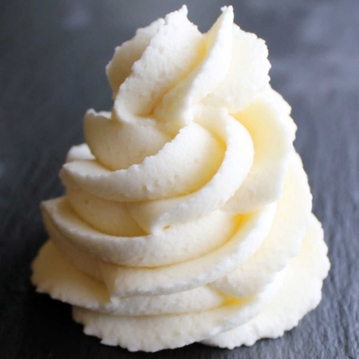 Swirl of piped cream cheese frosting made stiff for decorating cakes.