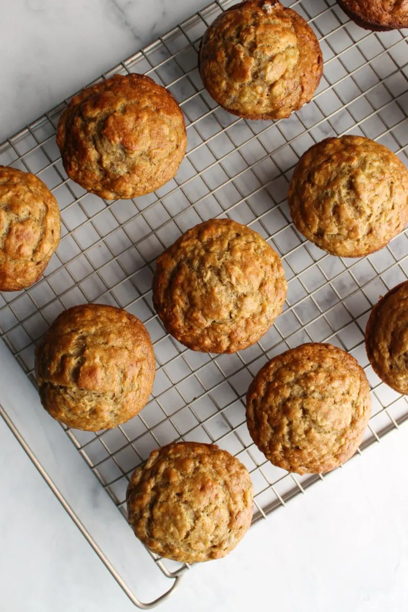 Looking down at a bunch of banana oatmeal muffins on a cooling rack 